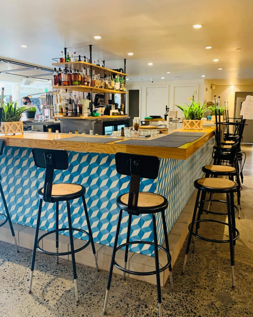 Blue and white patterned bar with stools in the hotel lobby