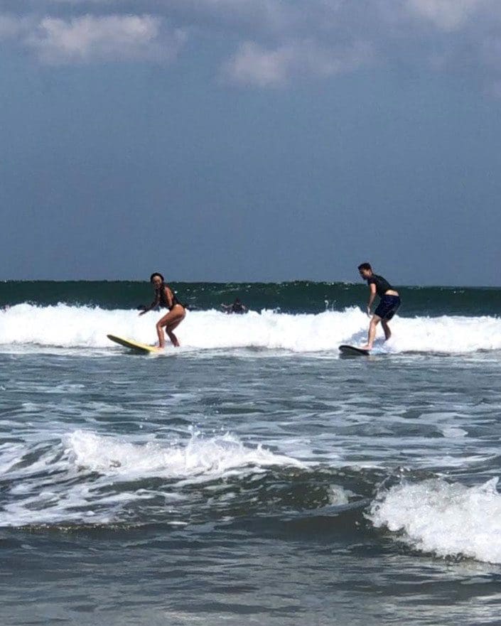 Two people catch their first waves in Bali