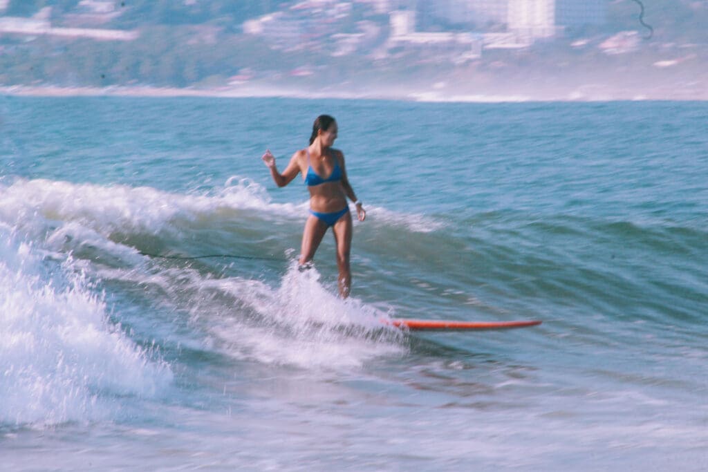 Girl surfing on a longboard in Mexico