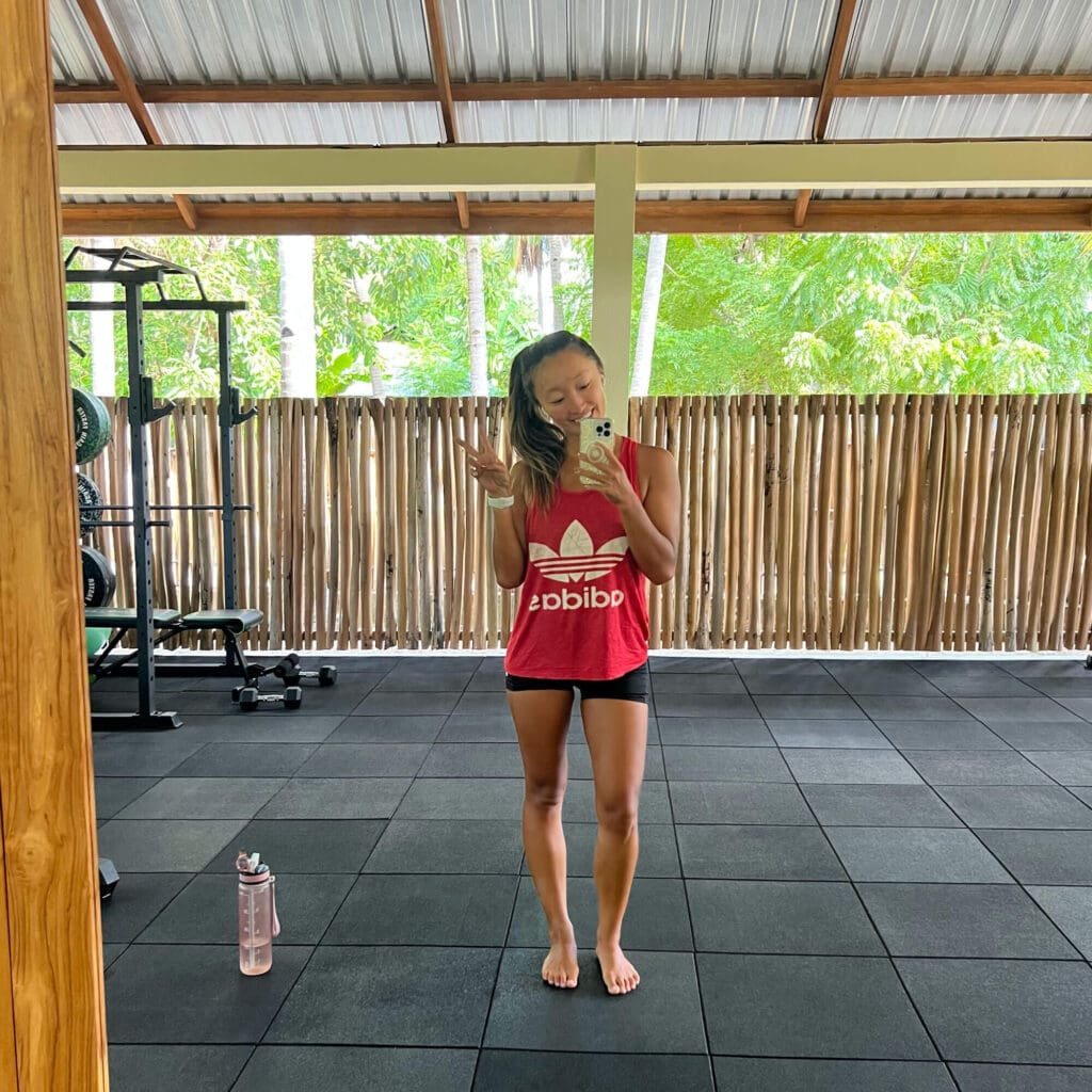 Girl posing in front of the mirror at the gym in Rote Island