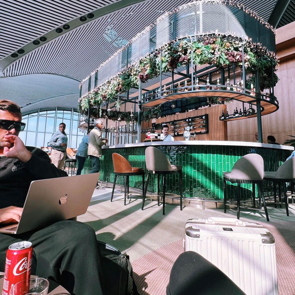 Man working on laptop in an airport lounge