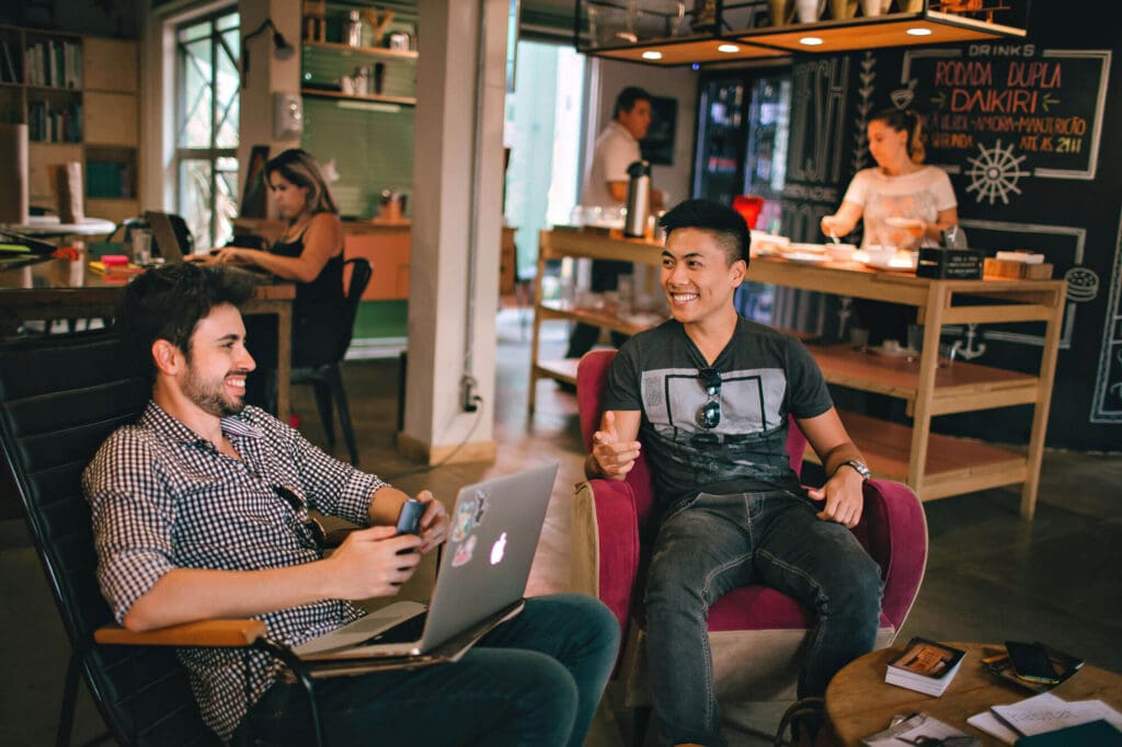 Two men socializing at a coworking hostel
